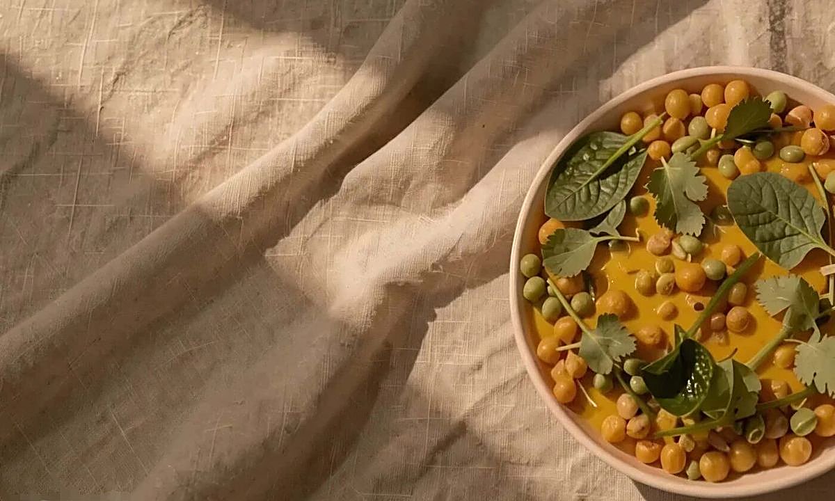 Chickpea and vegetable curry bowl on linen