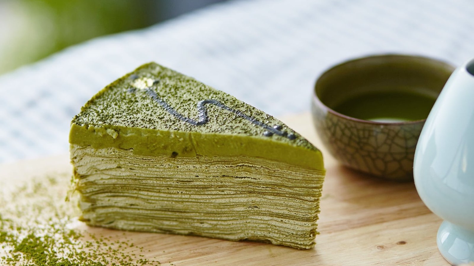 Layered matcha crepe cake, sliced
