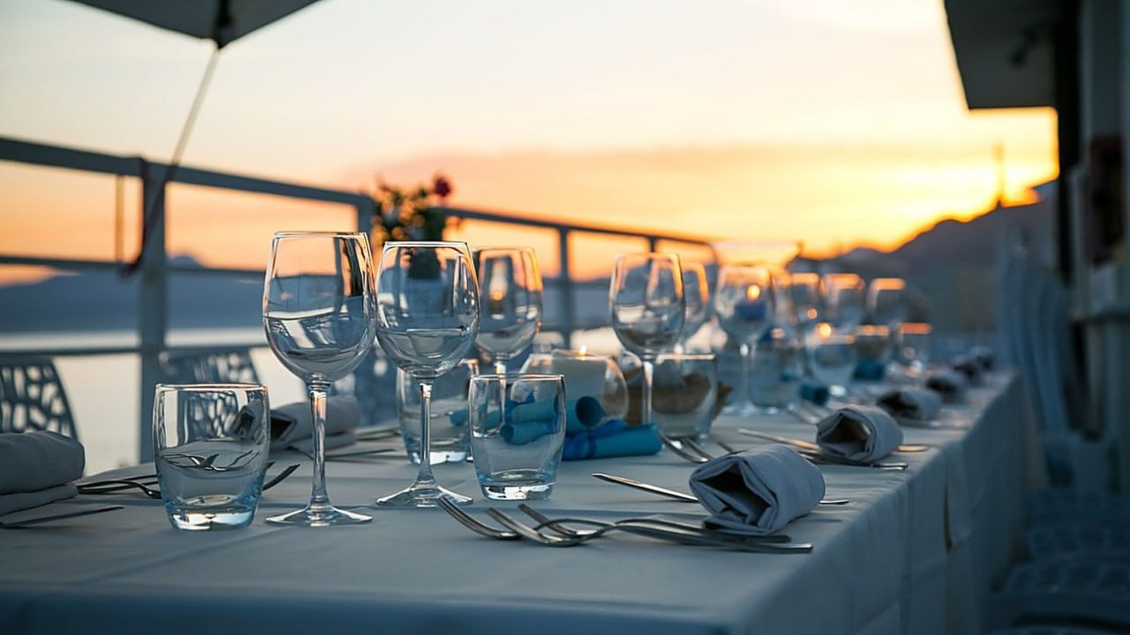 Set table with wine glasses at sunset